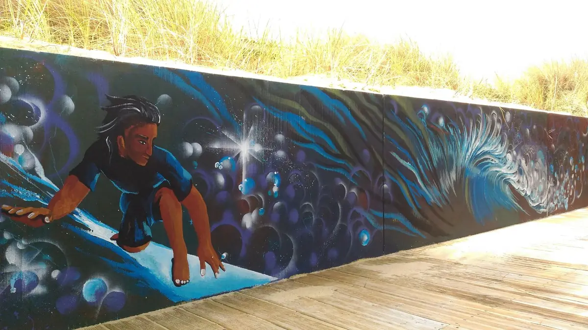 Fresque océanique avec un surfeur au bord d’une terrasse en bois